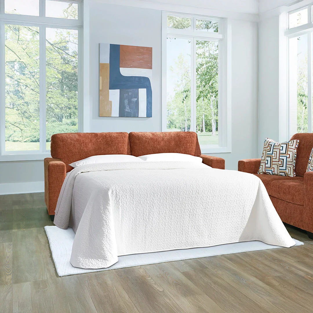 Navy blue sofa with bold accent pillows and playful modern style for living rooms